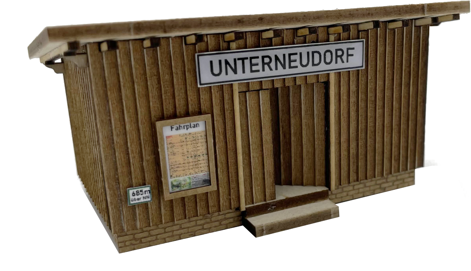 Bildbeschreibung: 
Dieses Bild beinhaltet eine Darstellung vom fertig montierten Modell aus dem Bausatz "Wartehaus Haltepunkt "Unterneudorf (H0)".  Es ist als Illustration und Vorschau für den Inhalt des Themenbereiches "Rund um den Bahnhof" gedacht. 
Das Bild ist zudem als Link zu weiterführenden Informationen zum Themenbereich "Rund um den Bahnhof" angelegt und kann damit zur vereinfachten Navigation genutzt werden.
