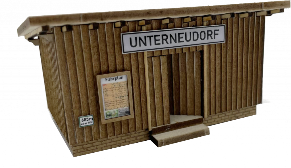 Bildbeschreibung: Produktbild des fertigen Modells des Bausatzes "Wartehaus Haltepunkt Unterneudorf (H0)"
Das Bild kann auch als Link zur Bauanleitung des Bausatzes genutzt werden
